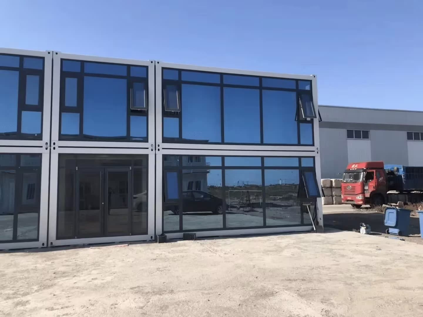 Two-story glass-front modular building configuration.