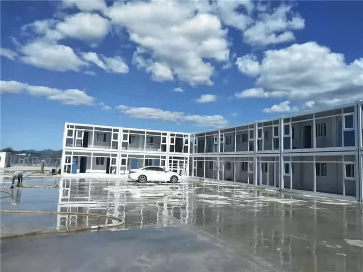 Two-story modular apartment complex around a courtyard.