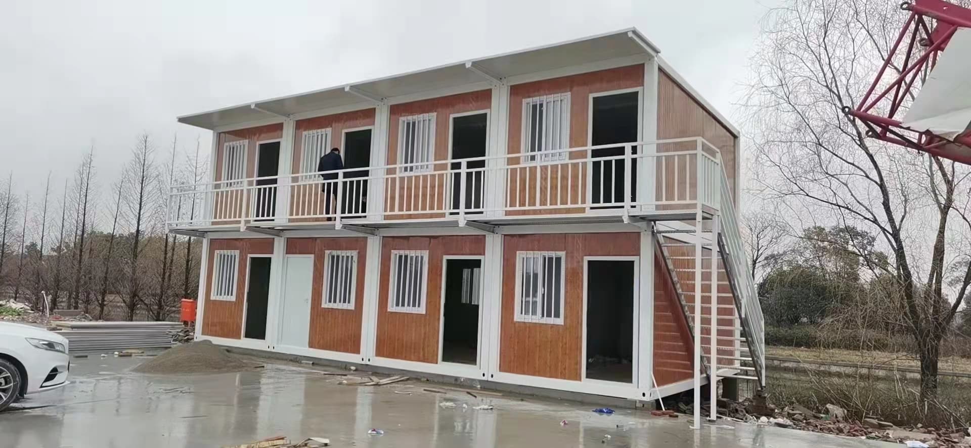 Two-story modular apartment building with a balcony walkway.