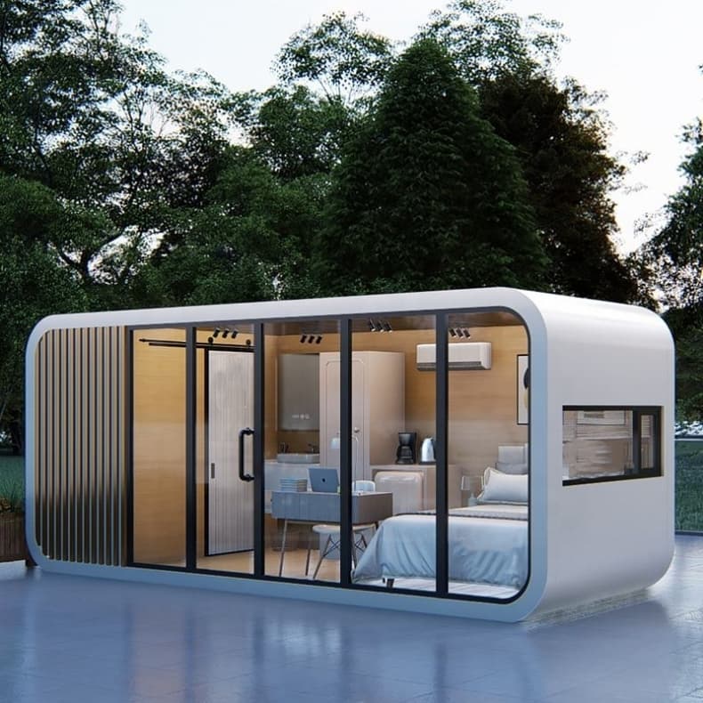 Rounded Apple Cabin with a glass facade and furnished interior visible.