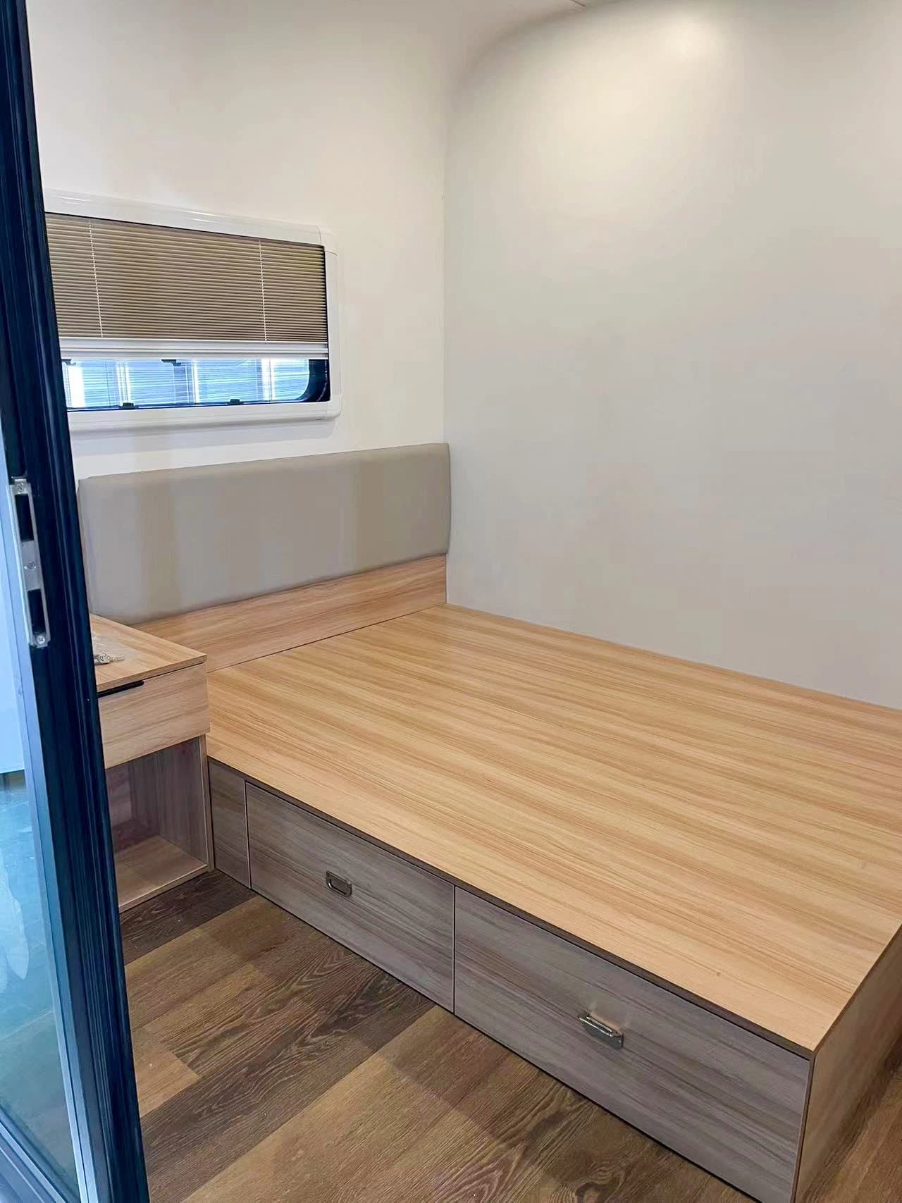 Apple Cabin bedroom with a wood platform bed and storage drawers.