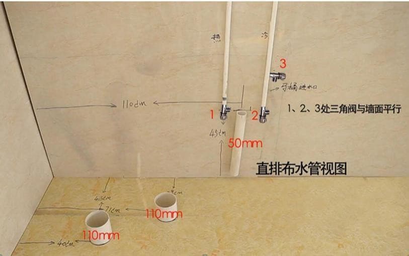 Photo of drains taken straight down through the floor for a bathroom pod: two 4 inch openings, with the hot and cold angle valves set parallel to the wall.