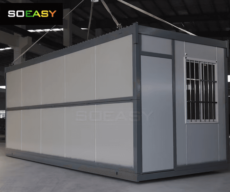 A folding emergency unit lifted by its corner lifting points in the factory.