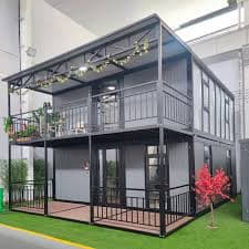 Two-story duplex container home with covered porches.