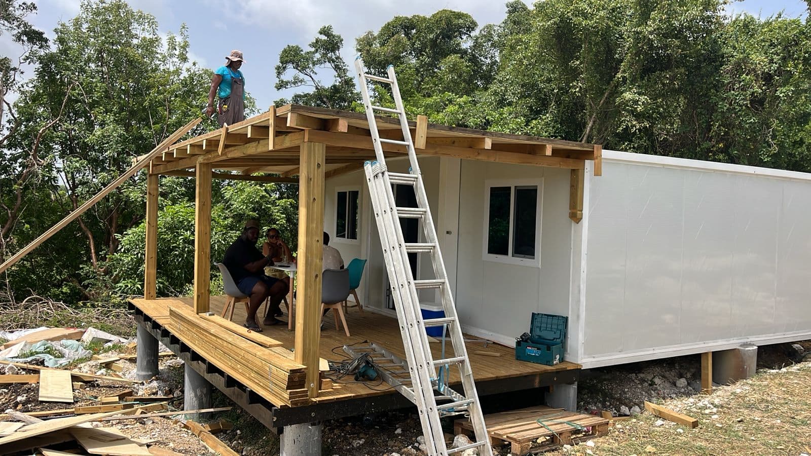 A delivered expandable home with a covered porch under assembly.