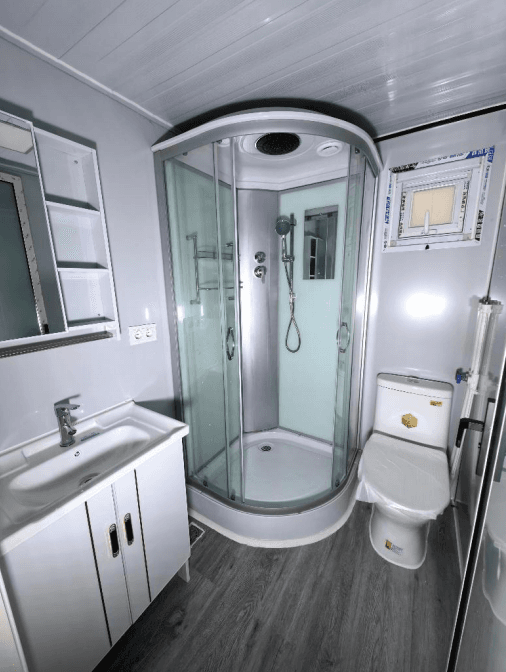 Bathroom with a glass shower stall and vanity.