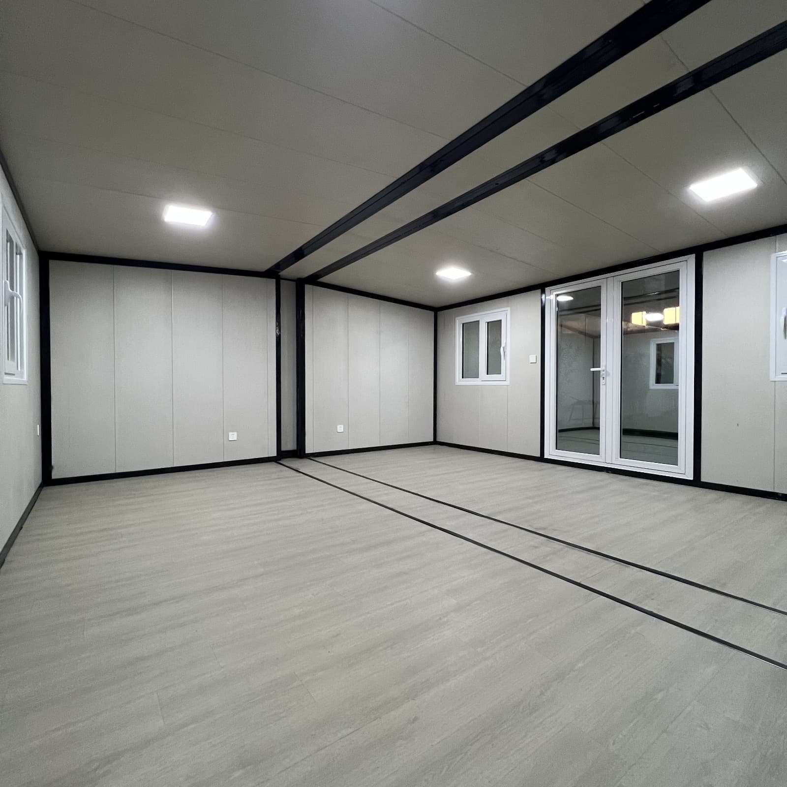 Open expandable interior with glass doors and vinyl plank flooring.