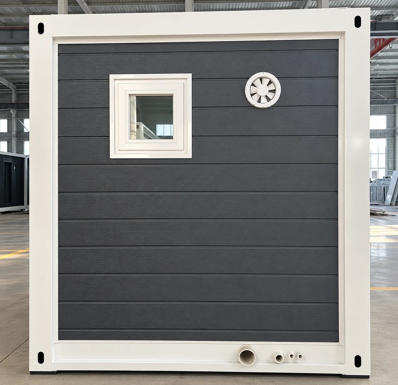 Rear wall of an expandable home: bathroom window, bathroom exhaust fan, and the sewer and water connections in the bottom frame.