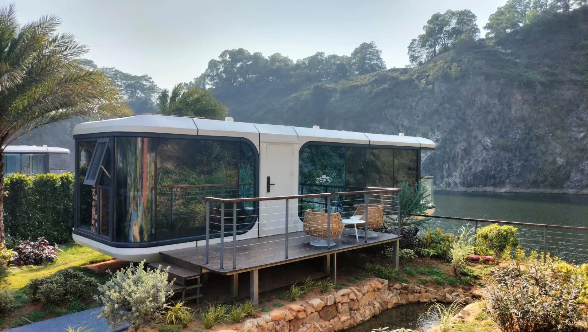 Space Capsule pod with a deck overlooking water.