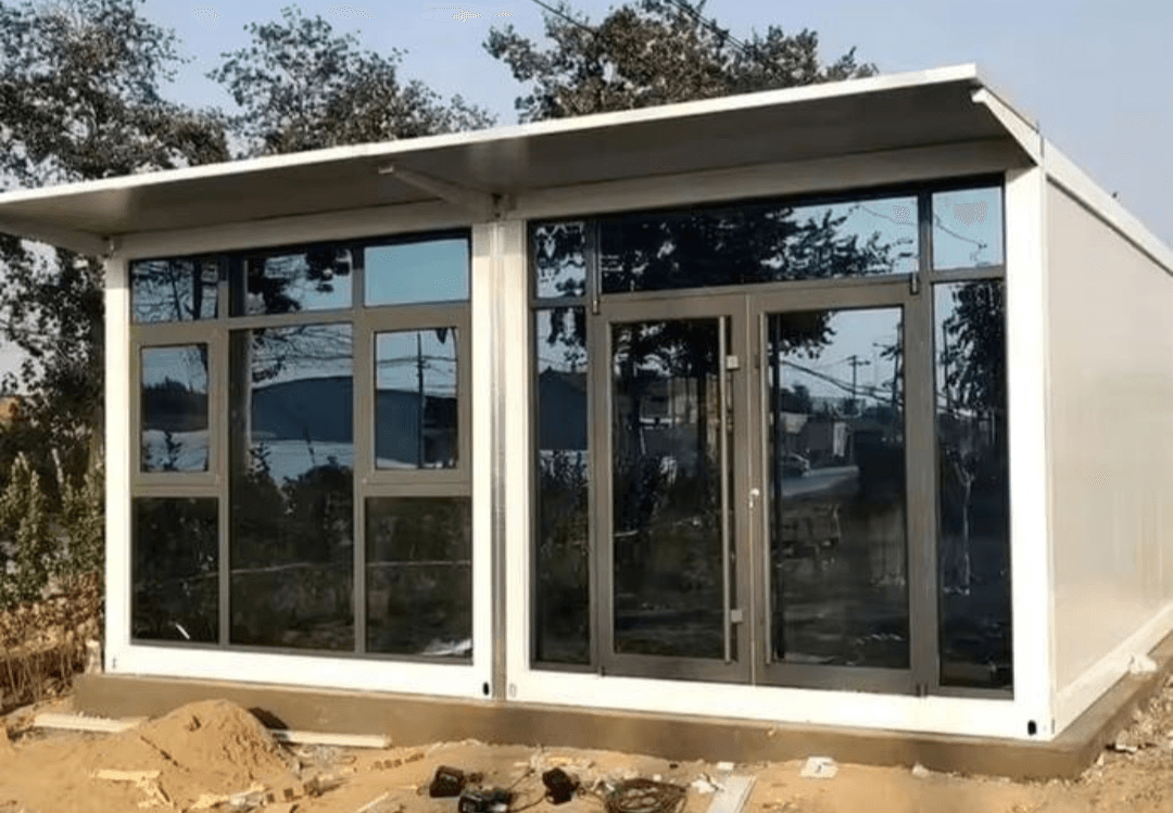 Single-module assembly home with a panoramic glass facade.
