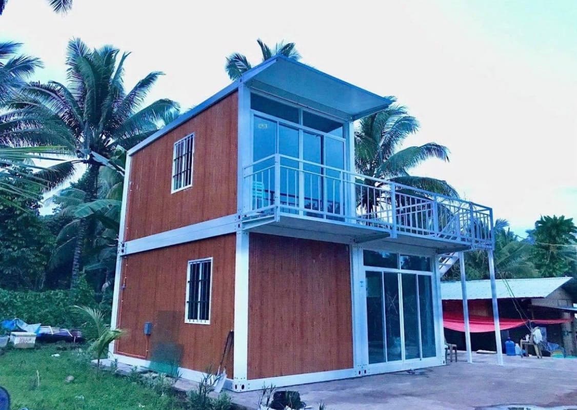 Assembly home with warm wood-tone exterior panels.